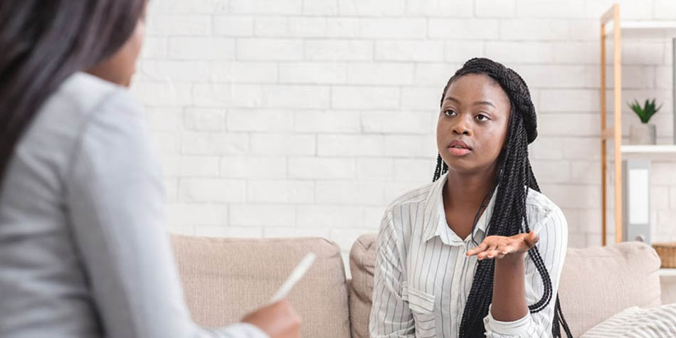 African American woman speaking to a therapist