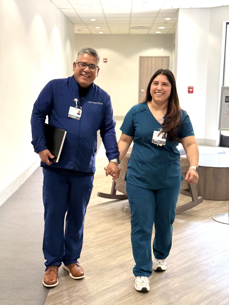 Aguirres at work: pete and melody aguirre walking in hospital hallway.